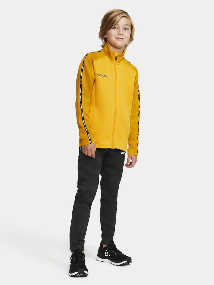 Craft - Squad 2.0 Full Zip Jr Sweden Yellow-Golden 134/140